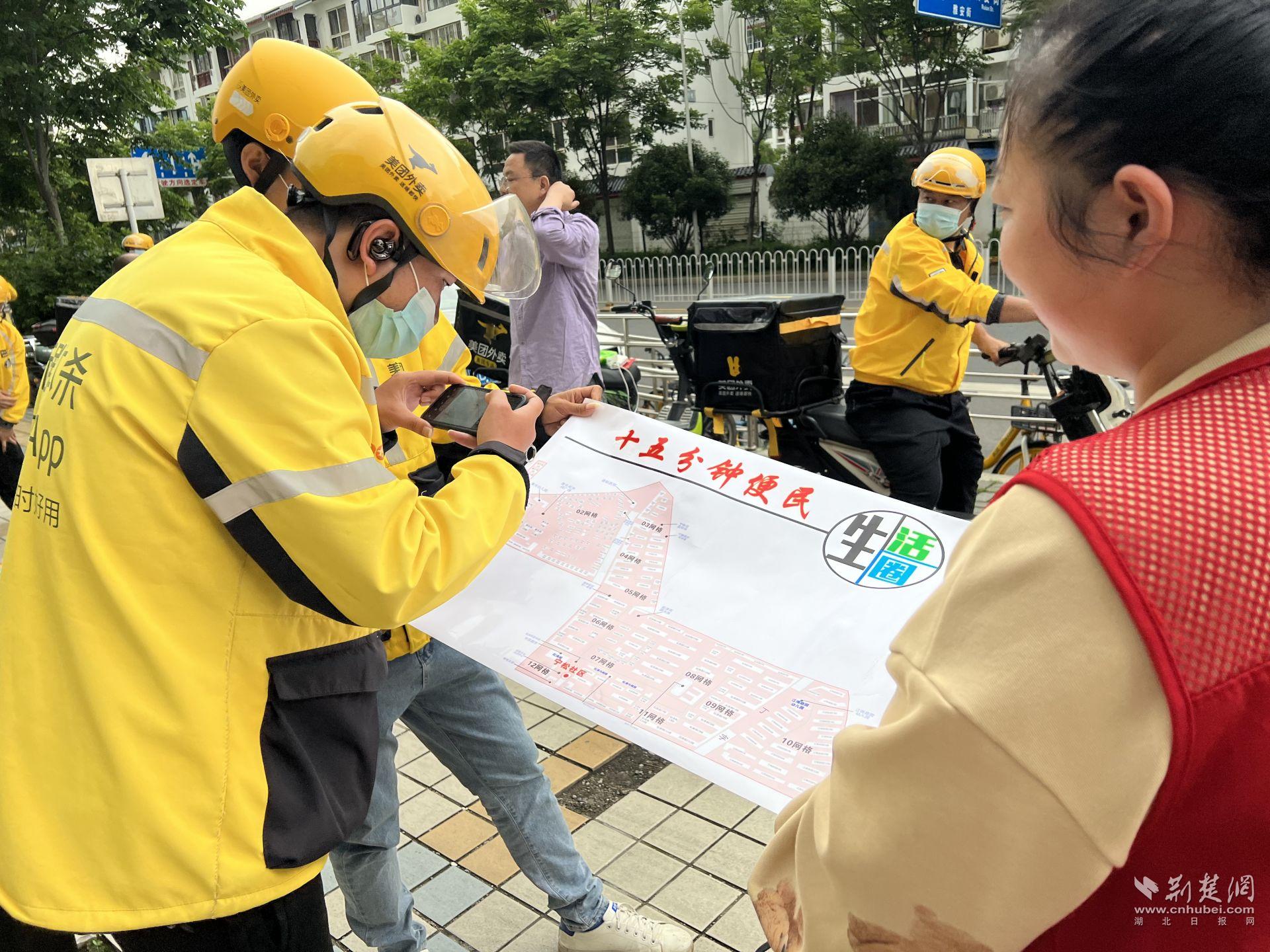 社区工作人员向外卖小哥介绍宁松社区15分钟生活圈.jpg.jpg
