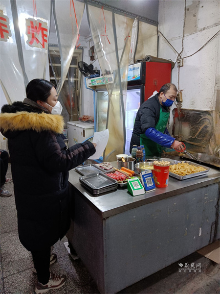 社区工作者对辖区小吃店进行食品安全宣传.jpg