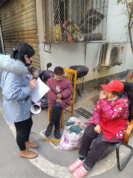 社区工作者在小区宣传普及冬季消防安全知识.jpg