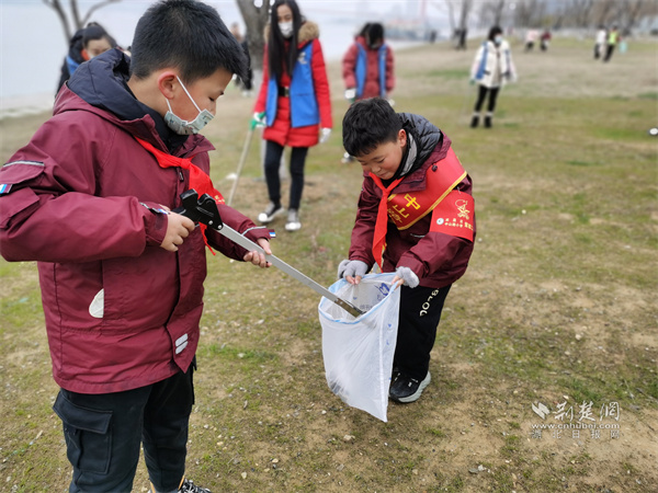 学生们正在江滩配合捡垃圾.jpg