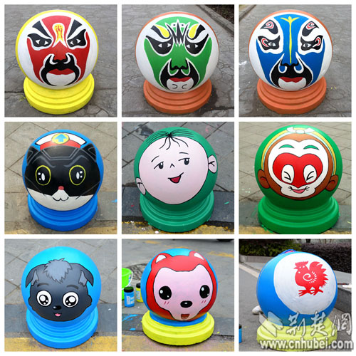 在汉江师范学院校园里,五颜六色的脸谱,剪纸和卡通形象彩绘石墩,吸引