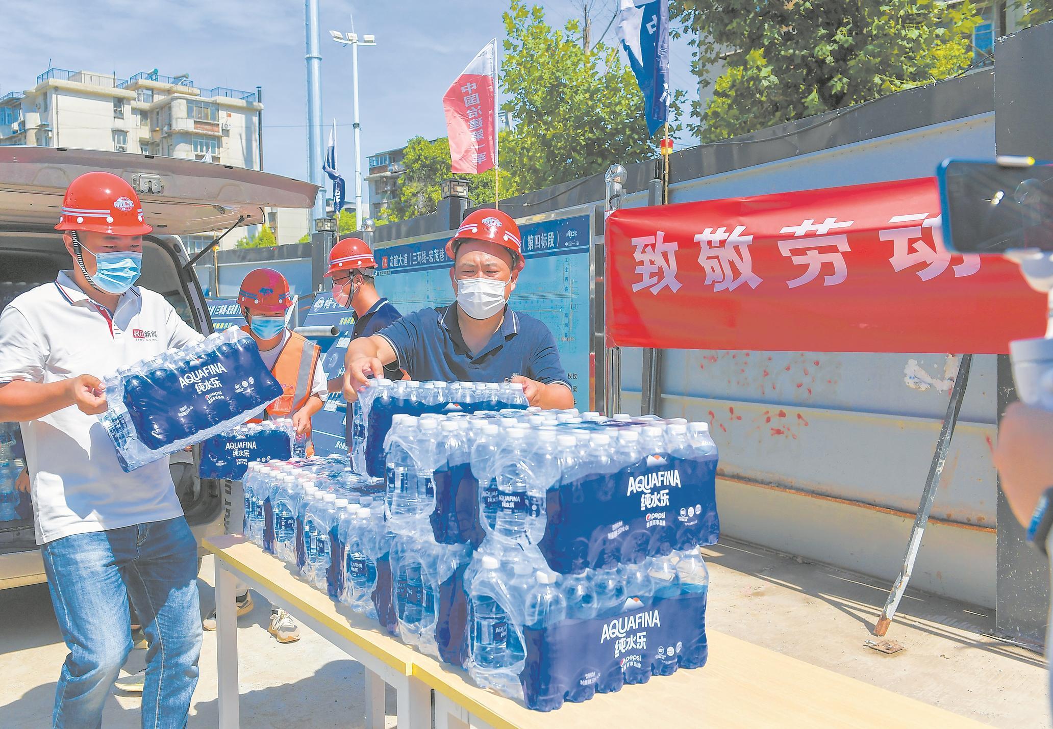 极目送清凉走进武汉一线工地2400瓶纯净水送到工友手上