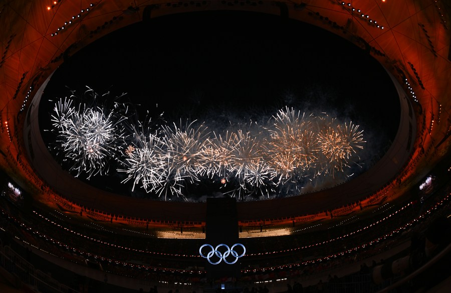 fireworks illuminate the night sky during the opening ceremony